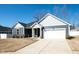 Attractive single-story home with gray siding, stone veneer, a two-car garage, and an inviting entrance at 403 Lagoon Ln, Mebane, NC 27302