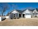 Well-maintained single-Gathering home featuring gray siding, stone accents, and a two-car garage at 403 Lagoon Ln, Mebane, NC 27302