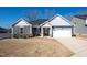 Charming single-story home with gray siding, stone accents, and a well-manicured front yard at 403 Lagoon Ln, Mebane, NC 27302