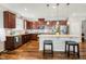 Beautiful kitchen with dark wood cabinets, granite countertops, stainless steel appliances, and a central island at 403 Lagoon Ln, Mebane, NC 27302