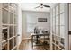 Home office with glass doors, a modern desk setup, and a comfortable workspace at 403 Lagoon Ln, Mebane, NC 27302
