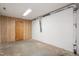 Unfinished basement space with concrete floor, wood door, and white walls at 407 Gooseneck Dr # A2, Cary, NC 27513