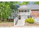 Charming condo featuring a covered entryway with white railing and a well-maintained yard at 407 Gooseneck Dr # A2, Cary, NC 27513