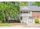 Charming condo featuring a covered entryway with white railing and a well-maintained yard at 407 Gooseneck Dr # A2, Cary, NC 27513