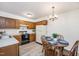 Eat-in kitchen features wood cabinetry, laminate countertops and new wood-look flooring at 407 Gooseneck Dr # A2, Cary, NC 27513