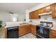 Efficient kitchen layout with wood cabinets, stainless steel sink, and modern appliances at 407 Gooseneck Dr # A2, Cary, NC 27513