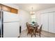 Cozy eat-in kitchen features a round wood table, chandelier, and white appliances at 407 Gooseneck Dr # A2, Cary, NC 27513