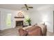 Bright living room with fireplace, ceiling fan, and ample natural light through a glass door at 407 Gooseneck Dr # A2, Cary, NC 27513