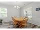 Formal dining room with wood floors, large windows, and classic wooden chairs at 421 Long Lake Dr, Fuquay Varina, NC 27526