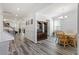 Open-concept dining area with natural light, wood floors, and a stylish light fixture at 421 Long Lake Dr, Fuquay Varina, NC 27526