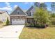 Charming two-story home with stone accents, well-manicured lawn, and attached two-car garage at 421 Long Lake Dr, Fuquay Varina, NC 27526