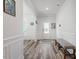 Bright foyer with wood-look floors, white walls, and a decorative bench at 421 Long Lake Dr, Fuquay Varina, NC 27526