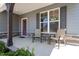 Covered front porch showcasing a seating area, stone accents, and a well-lit entryway at 421 Long Lake Dr, Fuquay Varina, NC 27526
