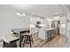 Open kitchen features white cabinets, stainless steel appliances, and an island with seating at 421 Long Lake Dr, Fuquay Varina, NC 27526