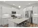 Modern kitchen with white cabinetry, stainless steel appliances, and a center island with barstool seating at 421 Long Lake Dr, Fuquay Varina, NC 27526