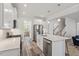 Modern open kitchen with white cabinetry, stainless appliances, and a center island at 421 Long Lake Dr, Fuquay Varina, NC 27526