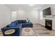 Inviting living room features a stylish blue sectional, fireplace, and neutral color palette at 421 Long Lake Dr, Fuquay Varina, NC 27526