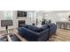 Beautiful living room featuring a fireplace, TV, and a comfortable blue sectional at 421 Long Lake Dr, Fuquay Varina, NC 27526