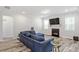 Cozy living room with a fireplace, plush seating, and plenty of natural light at 421 Long Lake Dr, Fuquay Varina, NC 27526