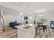 Open-concept living space with kitchen, dining area, and living room with fireplace at 421 Long Lake Dr, Fuquay Varina, NC 27526
