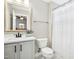 Clean bathroom with a vanity, toilet, shower curtain, and a large mirror offering ample natural light at 44 S Wilders Ridge Way, Clayton, NC 27527