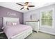 Cozy bedroom featuring a pastel colored wall, comfortable bed, and a window with natural light at 44 S Wilders Ridge Way, Clayton, NC 27527
