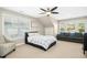 Spacious bedroom with a cozy sitting area, large windows, and a ceiling fan at 44 S Wilders Ridge Way, Clayton, NC 27527
