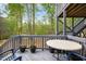 Wooden deck with blue railing and a table with potted plants at 44 S Wilders Ridge Way, Clayton, NC 27527