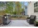 Outdoor deck featuring a stainless steel grill and a wicker chair at 44 S Wilders Ridge Way, Clayton, NC 27527