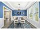 Beautiful dining room with a tray ceiling, large windows, and modern decor and beautiful floors at 44 S Wilders Ridge Way, Clayton, NC 27527