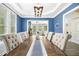 Elegant dining room with tray ceiling, modern lighting, and comfortable seating for a large Gathering to enjoy at 44 S Wilders Ridge Way, Clayton, NC 27527
