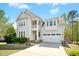 Beautiful two-story home with a two-car garage and a spacious driveway and well manicured lawn at 44 S Wilders Ridge Way, Clayton, NC 27527