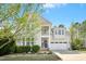 Charming two-story home with a welcoming front porch and a well-manicured lawn and a two car garage at 44 S Wilders Ridge Way, Clayton, NC 27527