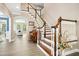Elegant foyer featuring hardwood floors, a staircase with white balusters, and a view of the living room at 44 S Wilders Ridge Way, Clayton, NC 27527