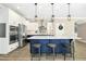 Bright kitchen with large island, stainless appliances, and modern pendant lights at 44 S Wilders Ridge Way, Clayton, NC 27527