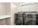 Convenient laundry room equipped with modern washer and dryer units and ample storage at 44 S Wilders Ridge Way, Clayton, NC 27527