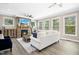 Bright living room with stone fireplace, large windows, and modern ceiling fan at 44 S Wilders Ridge Way, Clayton, NC 27527