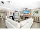 Open-concept living room with a stone fireplace, hardwood floors, and comfortable seating at 44 S Wilders Ridge Way, Clayton, NC 27527