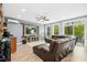 Spacious living room with a large leather sectional, TV, and natural light at 44 S Wilders Ridge Way, Clayton, NC 27527