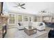 Spacious living room featuring fireplace, plush seating, and an open layout to kitchen at 44 S Wilders Ridge Way, Clayton, NC 27527