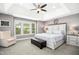 Spacious main bedroom with tray ceiling, plush carpet, large windows and an ensuite bathroom at 44 S Wilders Ridge Way, Clayton, NC 27527