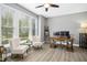 Well-lit office space with a modern desk, comfortable seating, and large windows and laminate floors at 44 S Wilders Ridge Way, Clayton, NC 27527