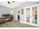 Spacious office with French doors, modern desk, and multiple computer monitors and neutral gray paint at 44 S Wilders Ridge Way, Clayton, NC 27527