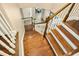 Beautiful staircase with hardwood treads, white risers, and elegant white railings leading to the lower level at 44 S Wilders Ridge Way, Clayton, NC 27527