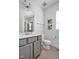 Clean bathroom featuring gray vanity, white countertops, toilet, and artwork at 490 Boulder Point Dr, Chapel Hill, NC 27516