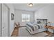 Inviting bedroom with natural light, rocking chair, and comfortable striped bedding at 490 Boulder Point Dr, Chapel Hill, NC 27516