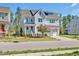 Charming two-story home with manicured lawn, inviting front porch, and attached two-car garage at 490 Boulder Point Dr, Chapel Hill, NC 27516
