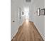 Bright hallway with hardwood floors and white walls, connecting different rooms in the home at 490 Boulder Point Dr, Chapel Hill, NC 27516