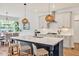 Contemporary kitchen with island, counter seating, and view of dining area at 490 Boulder Point Dr, Chapel Hill, NC 27516