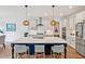 Modern kitchen with large island, pendant lighting, and stainless steel appliances at 490 Boulder Point Dr, Chapel Hill, NC 27516